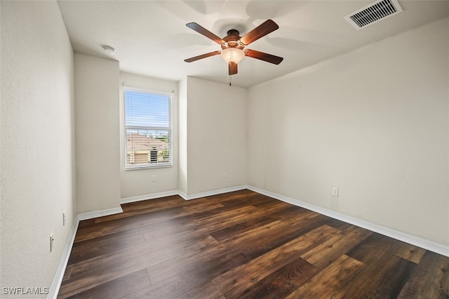 empty room with visible vents, ceiling fan, baseboards, and wood finished floors