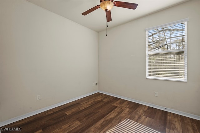 empty room featuring ceiling fan, wood finished floors, and baseboards