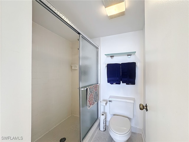 bathroom with tile patterned flooring, toilet, and a shower with shower door