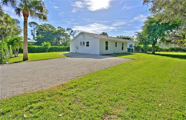 rear view of property featuring a lawn