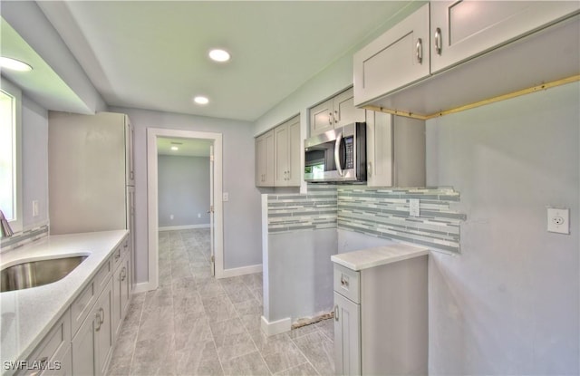 kitchen with decorative backsplash and sink