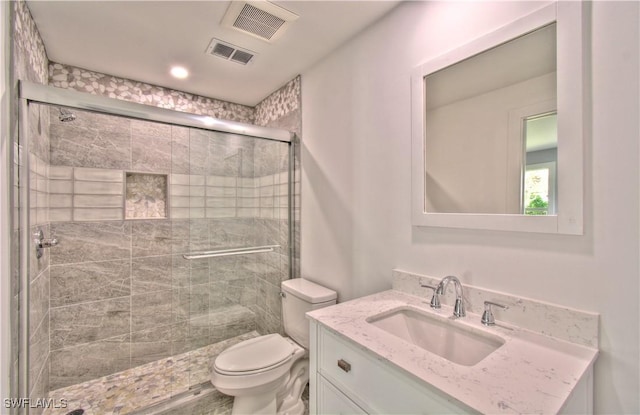 bathroom with vanity, toilet, and walk in shower