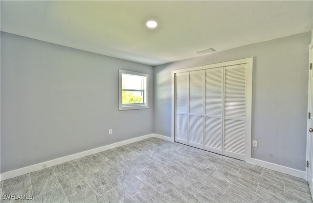 unfurnished bedroom with a closet