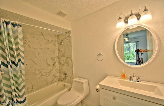 full bathroom featuring ceiling fan, a textured ceiling, toilet, shower / bath combo with shower curtain, and vanity