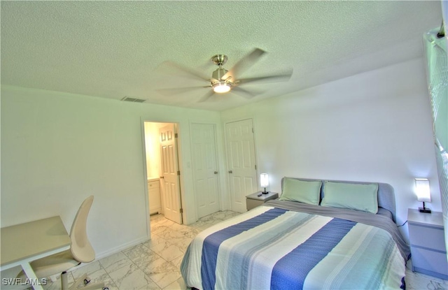 bedroom featuring ensuite bath, ceiling fan, and a textured ceiling