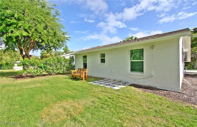 rear view of house featuring a yard