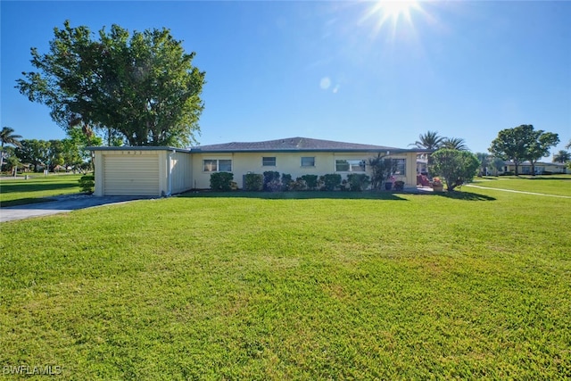 single story home with a garage and a front lawn