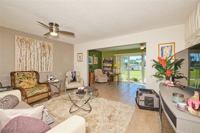 tiled living room with a textured ceiling and ceiling fan