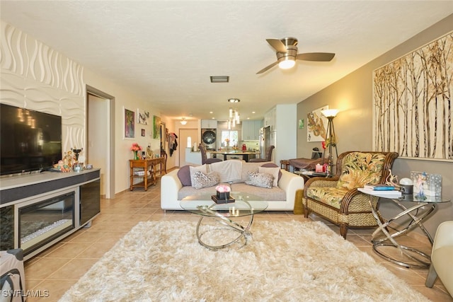 living room with light tile patterned flooring and ceiling fan