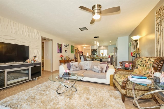 living room with ceiling fan and light tile patterned flooring