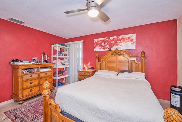 bedroom featuring light tile patterned floors and ceiling fan