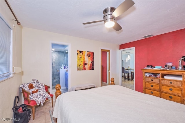 bedroom featuring light tile patterned flooring, ceiling fan, and ensuite bathroom