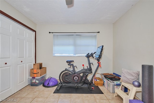 exercise room featuring light tile patterned floors