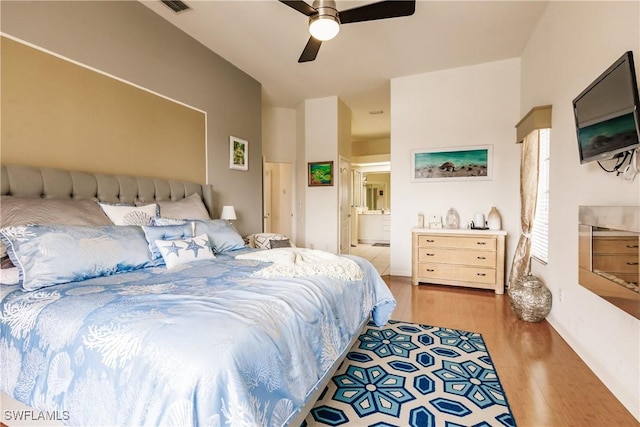 bedroom featuring ensuite bathroom, ceiling fan, and light hardwood / wood-style flooring