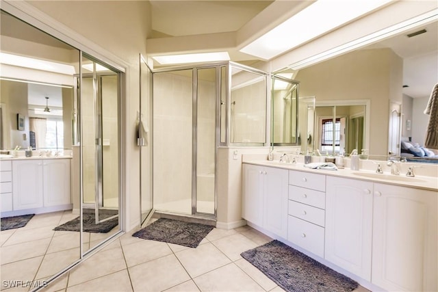 bathroom featuring tile patterned flooring, vanity, and a shower with shower door