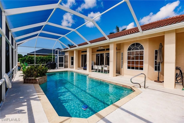 view of pool with a patio, ceiling fan, a lanai, and a grill