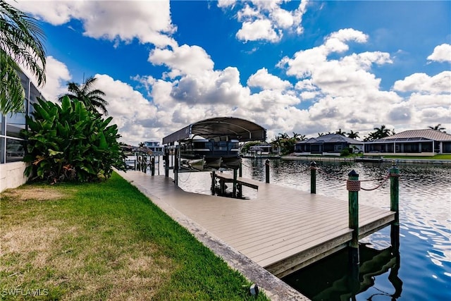 dock area featuring a lawn and a water view