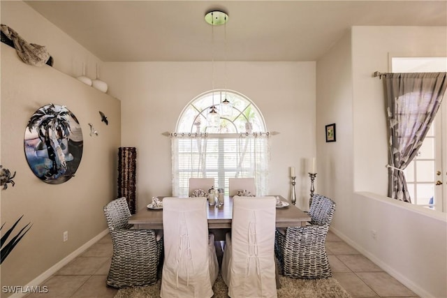 dining space featuring light tile patterned flooring