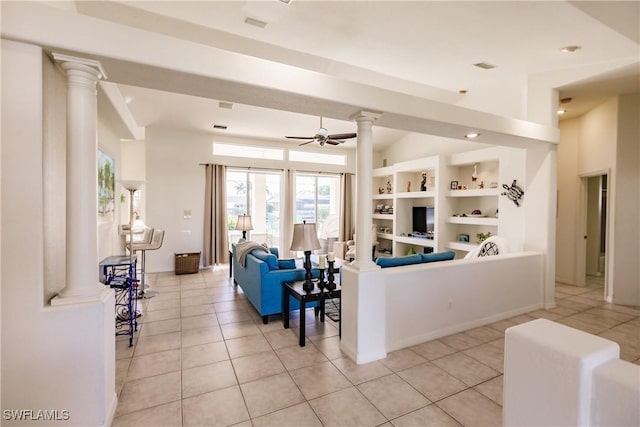 tiled living room with ceiling fan and built in shelves