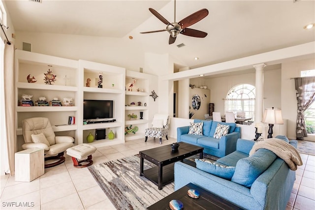 living room with ceiling fan, light tile patterned flooring, decorative columns, and vaulted ceiling