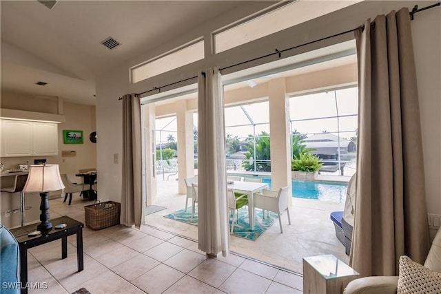 doorway with a wealth of natural light and light tile patterned floors