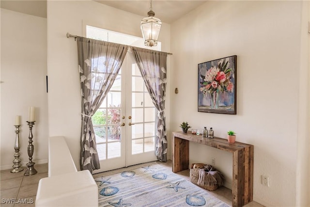 doorway with french doors and light tile patterned floors