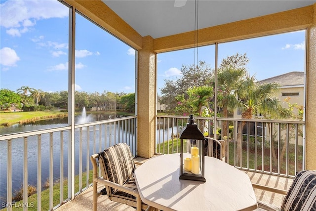 sunroom / solarium featuring a water view