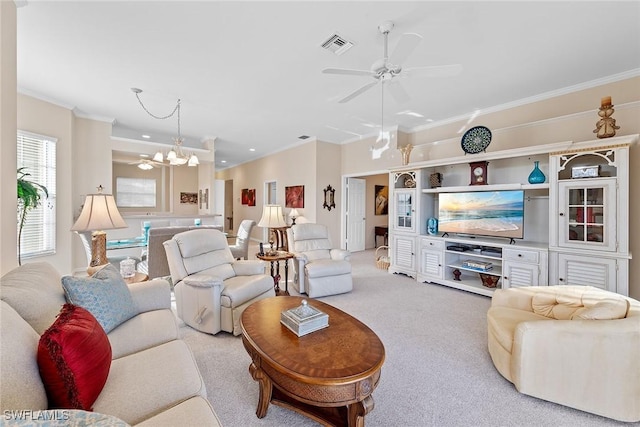 carpeted living room featuring ceiling fan with notable chandelier and ornamental molding