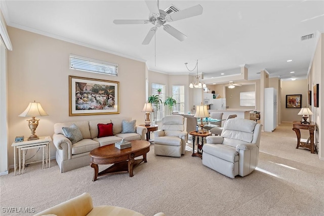 living room with light carpet, ceiling fan with notable chandelier, and ornamental molding