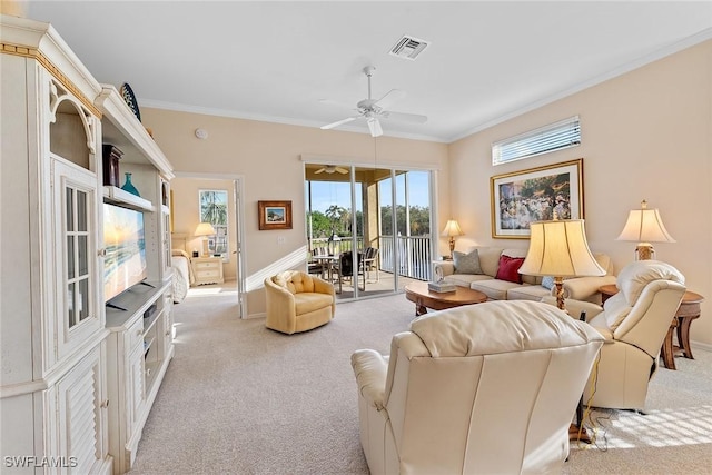 carpeted living room with crown molding and ceiling fan