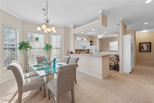 dining space featuring ceiling fan with notable chandelier, crown molding, and light carpet