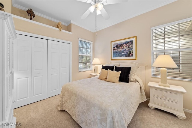 bedroom with a closet, light colored carpet, ceiling fan, and crown molding