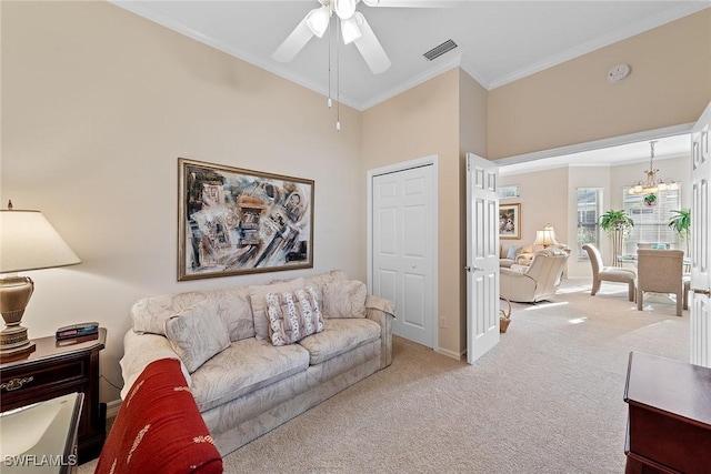 carpeted living room with ceiling fan with notable chandelier, a towering ceiling, and crown molding