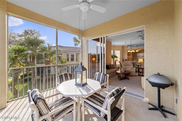 sunroom featuring ceiling fan and a healthy amount of sunlight