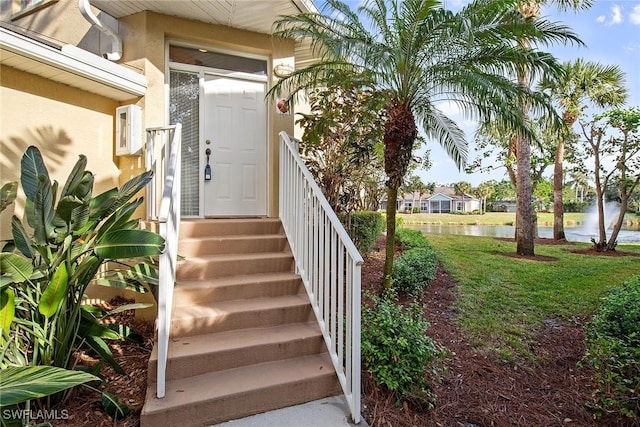 view of exterior entry with a water view