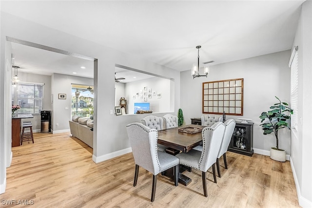 dining room with a chandelier and light wood-type flooring