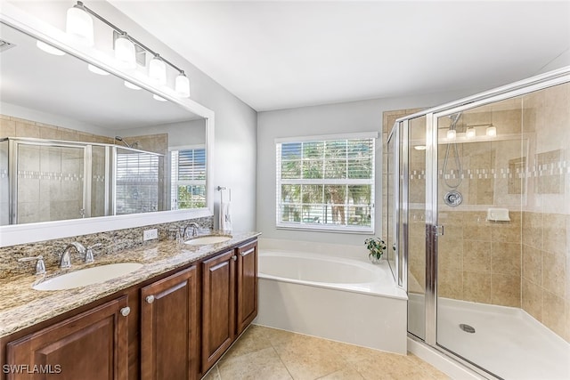 bathroom featuring tile patterned floors, vanity, and shower with separate bathtub