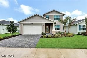 view of front of house with a front yard and a garage