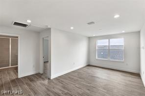 unfurnished room featuring dark hardwood / wood-style flooring