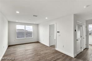 spare room featuring dark hardwood / wood-style flooring