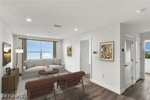 living room with dark hardwood / wood-style flooring