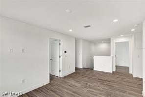 empty room featuring dark hardwood / wood-style flooring