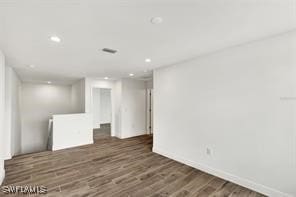 unfurnished room with dark hardwood / wood-style floors