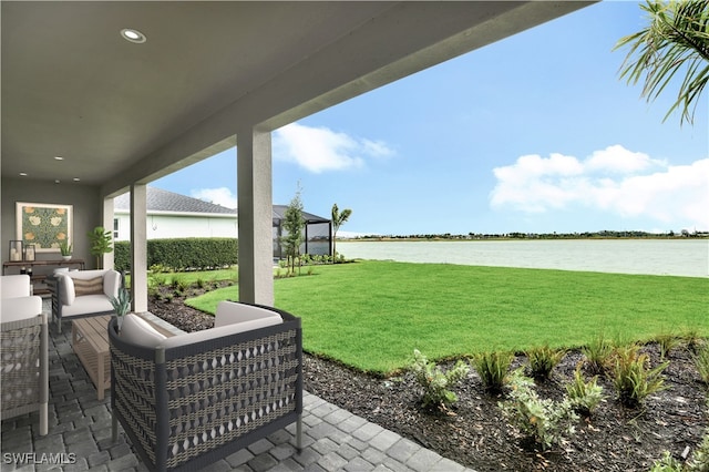 view of yard with an outdoor living space, a water view, and a patio