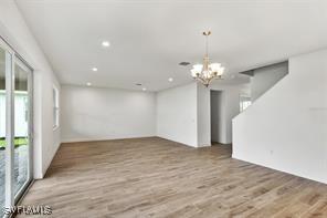 interior space with a notable chandelier and hardwood / wood-style flooring