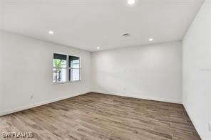 spare room with wood-type flooring