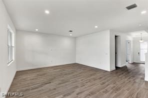 spare room featuring dark hardwood / wood-style floors