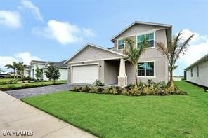 view of front facade featuring a front yard and a garage