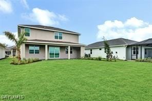 rear view of house with a lawn