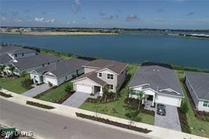 birds eye view of property with a water view